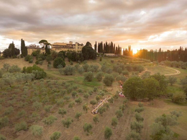 Aerial view of Como Castello del Nero among Tuscan olive groves at sunset, Mitheo Events