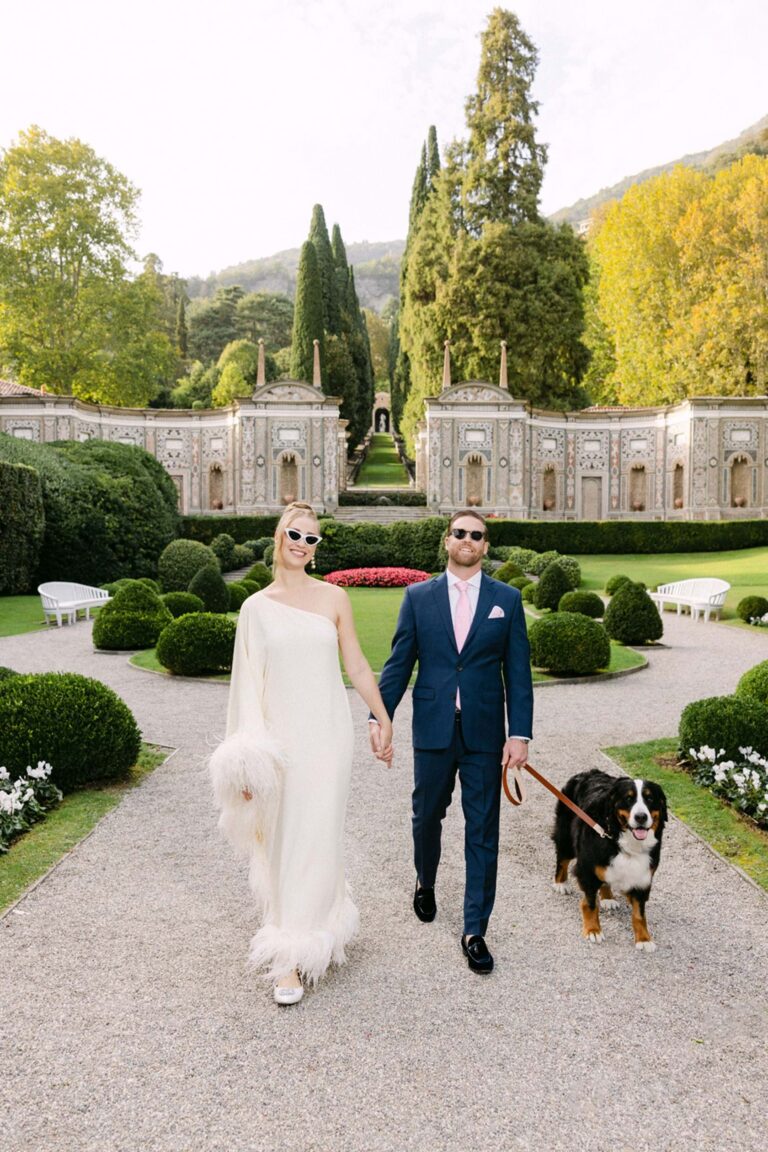 A couple and their dog walk through a formal garden on Lake Como, Mitheo Events