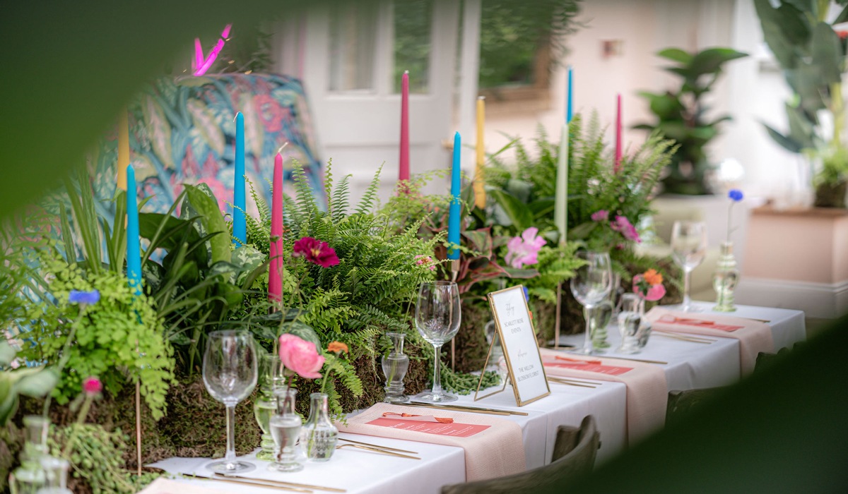 A long table set with coloured candles, ferns and flowers, Montigo Resorts Somerset at Charlton House