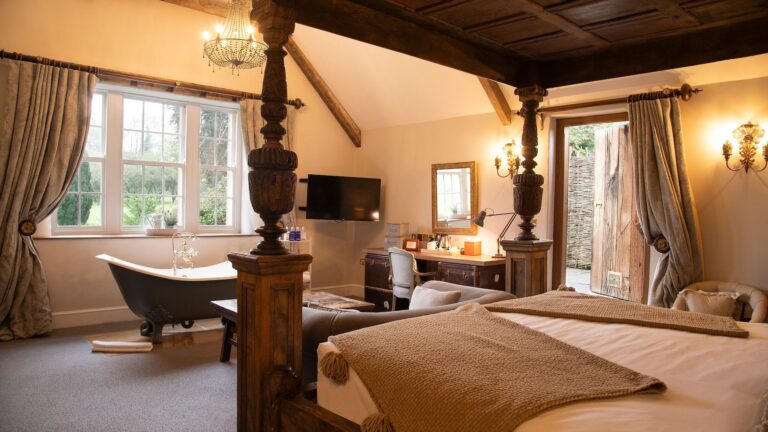A bedroom with a roll top bath beside the bed, Montigo Resorts Somerset at Charlton House