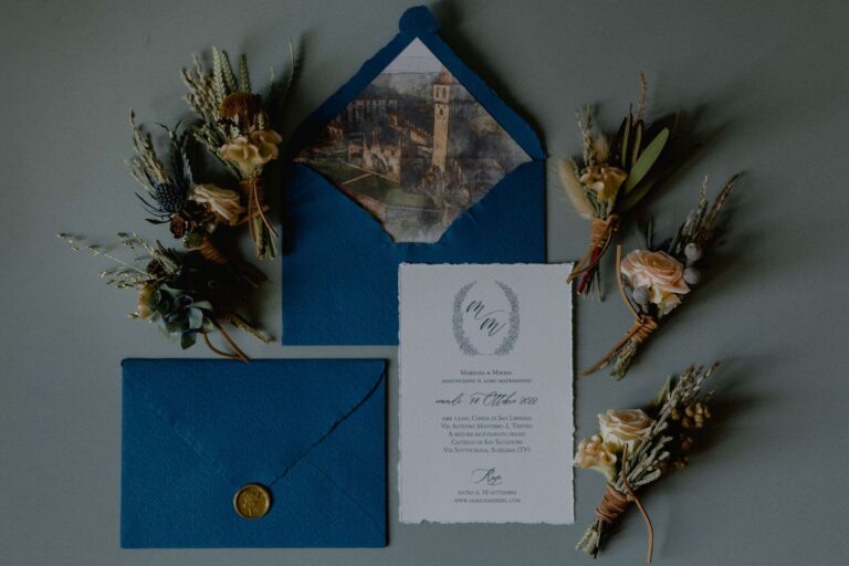 Blue envelope invitation suite with wax seal and dried-flower buttonholes, More Than Weddings