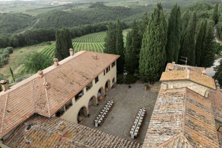 Long tables laid in the courtyard at Quercia al Poggio, Tuscany, seen from above, More Than Weddings