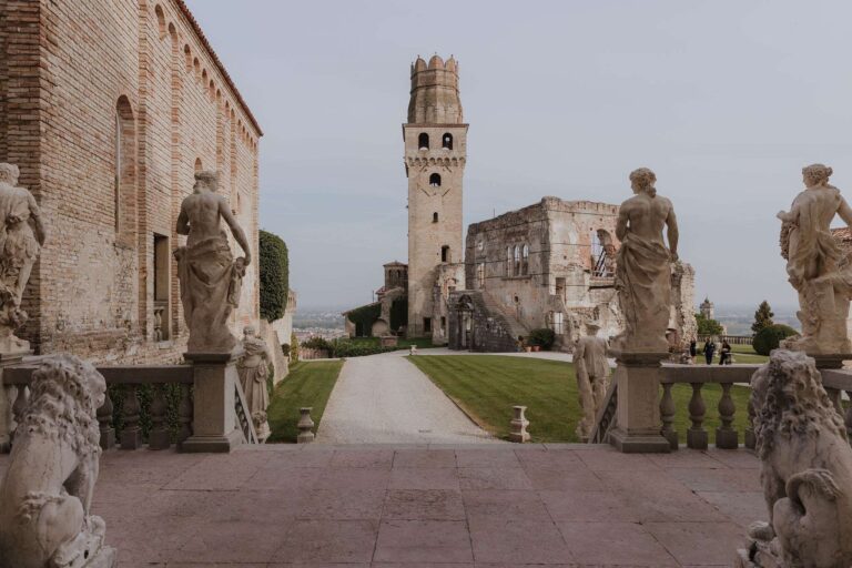 Statue-lined terrace and tower at Castello di San Salvatore, More Than Weddings