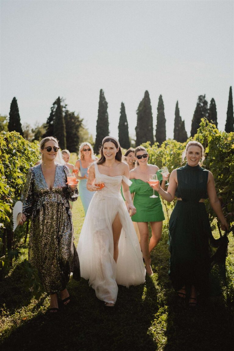 Bride walking with friends through a Valpolicella vineyard, More Than Weddings