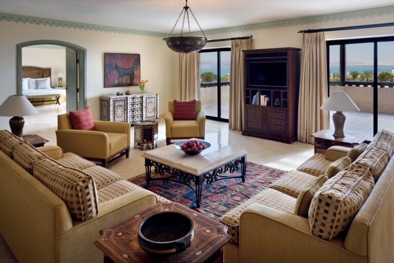 Oriental-style living room with sofas and a view towards the Dead Sea, Mövenpick Resort & Spa Dead Sea