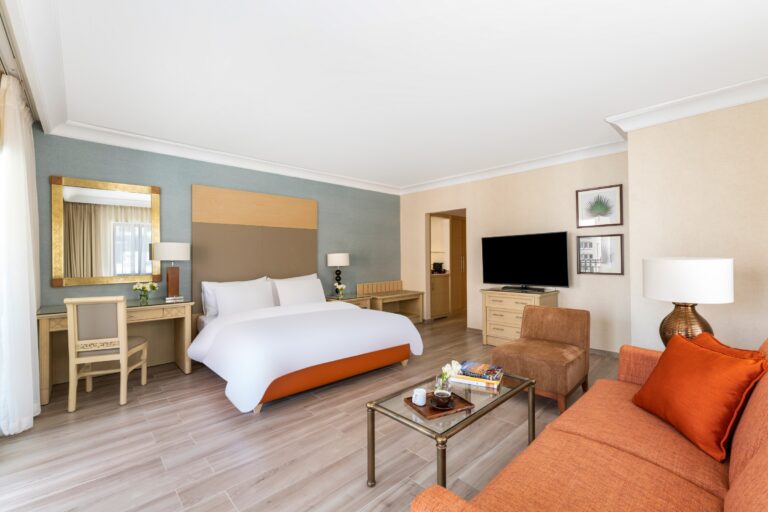 Bed with separate sitting area and sofa, Mövenpick Resort Petra