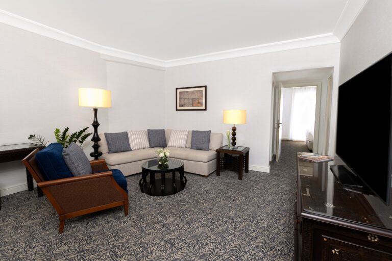 Living room with corner sofa and armchair, Mövenpick Resort Petra