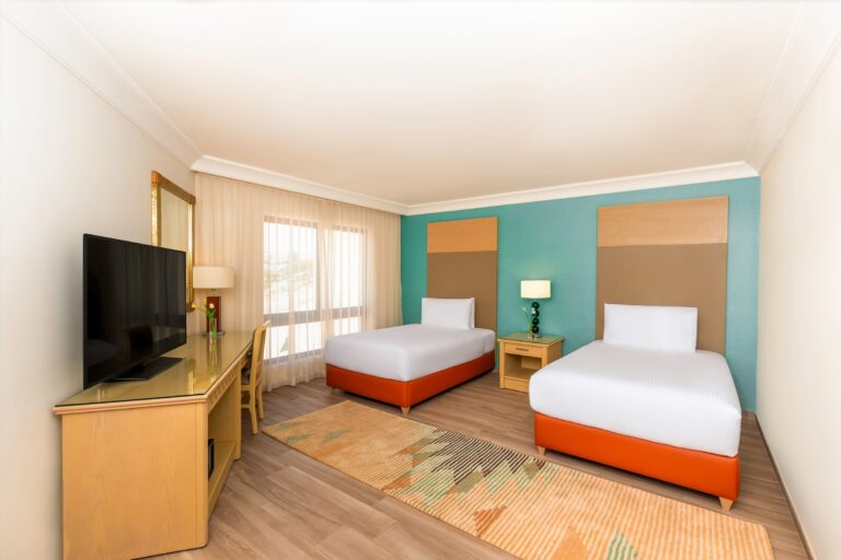 Twin beds with desk and television, Mövenpick Resort Petra