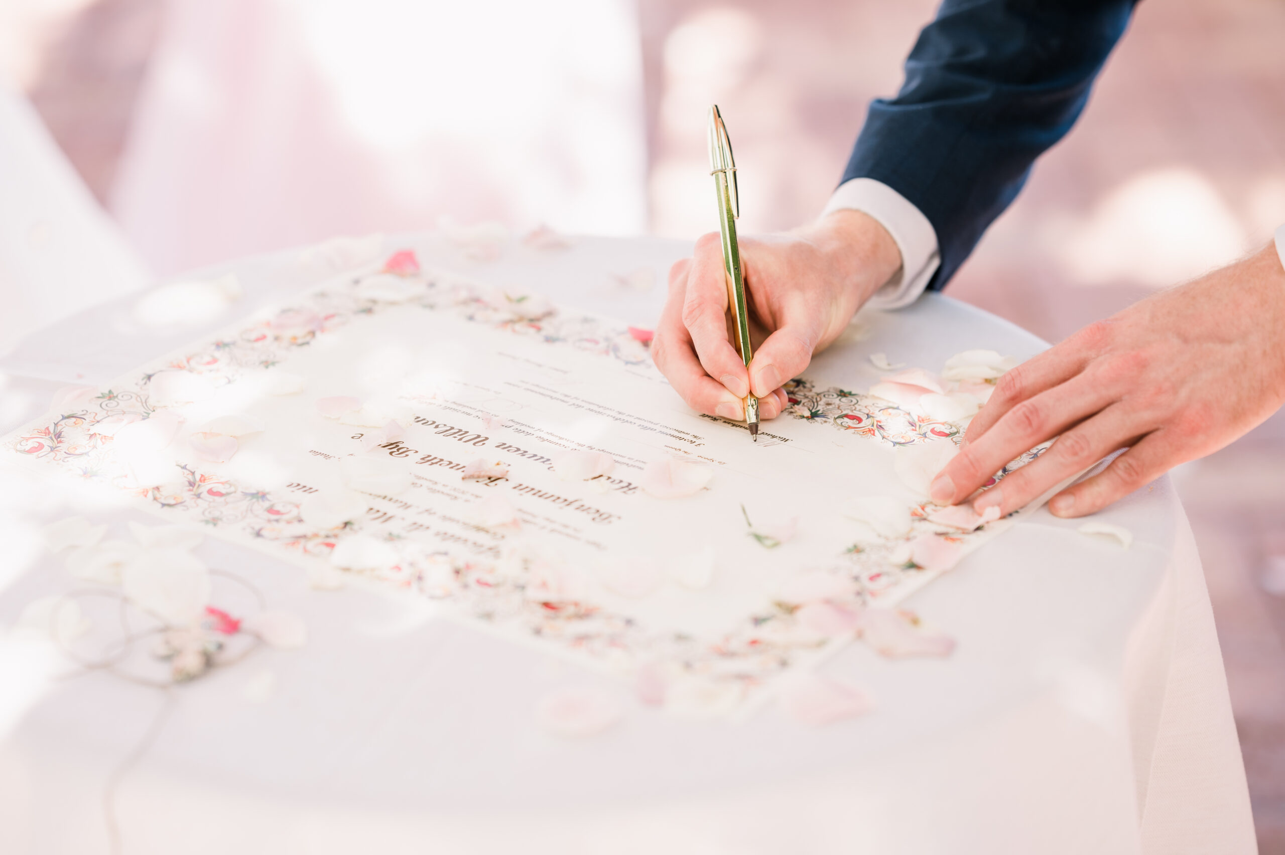 Signing the wedding certificate on a table scattered with petals, Mr and Mrs Wedding In Italy