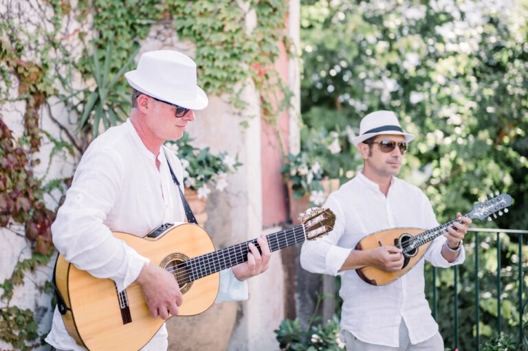 A guitarist and a mandolin player in white hats playing for the guests, Mr and Mrs Wedding In Italy