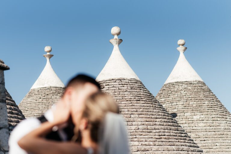 The couple in front of three trulli roofs, Puglia, Mr and Mrs Wedding In Italy