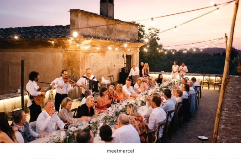 A long outdoor wedding dinner table under string lights at golden hour., MR Music Italy