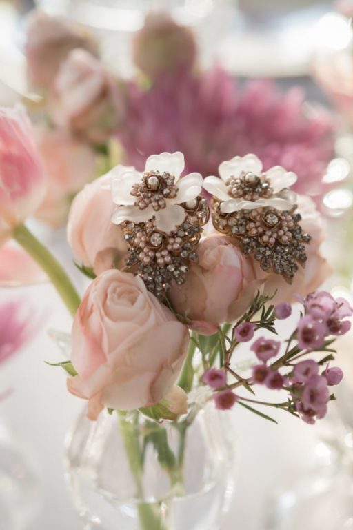 Blush roses and wax flowers with jewelled brooch details in a glass vase., My Dubai Wedding Planner