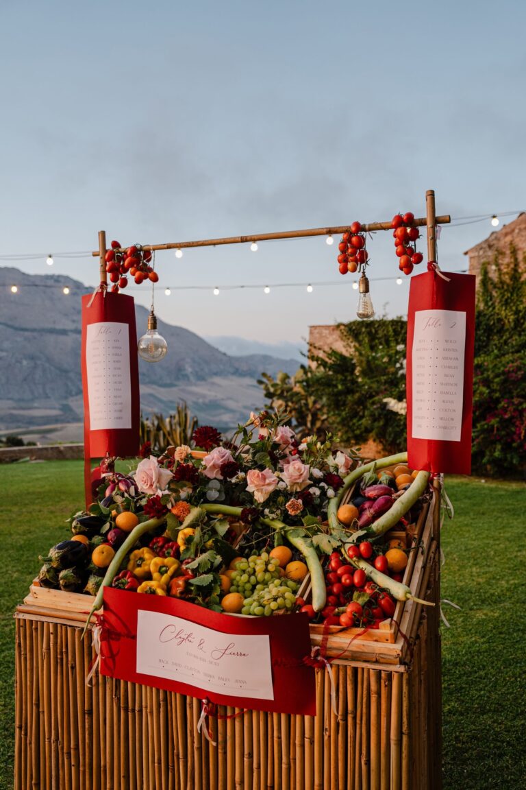 A seating plan built as a market stall: peppers, tomatoes, oranges, aubergines, My Sicily Wedding
