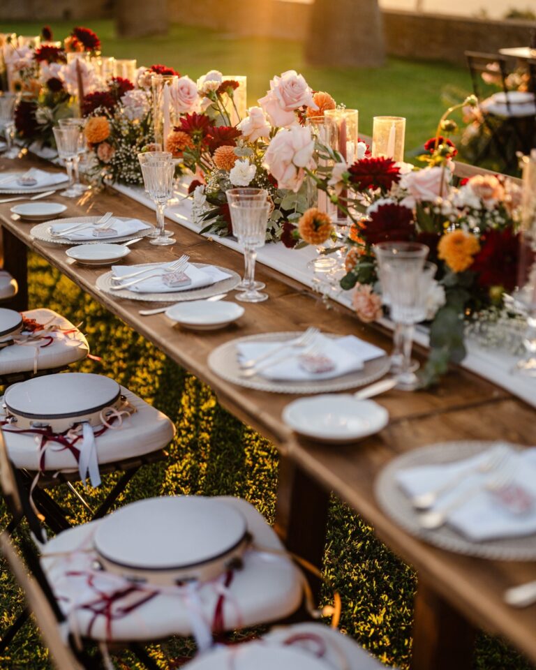 A tambourine tied with burgundy ribbon on every chair, dahlias down the runner, My Sicily Wedding