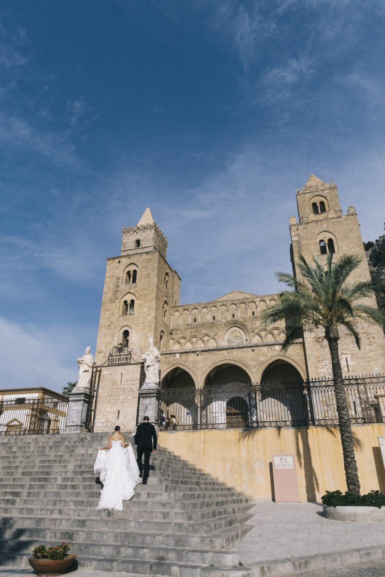 Climbing the steps of Cefalu cathedral, the twin Norman towers above, My Sicily Wedding