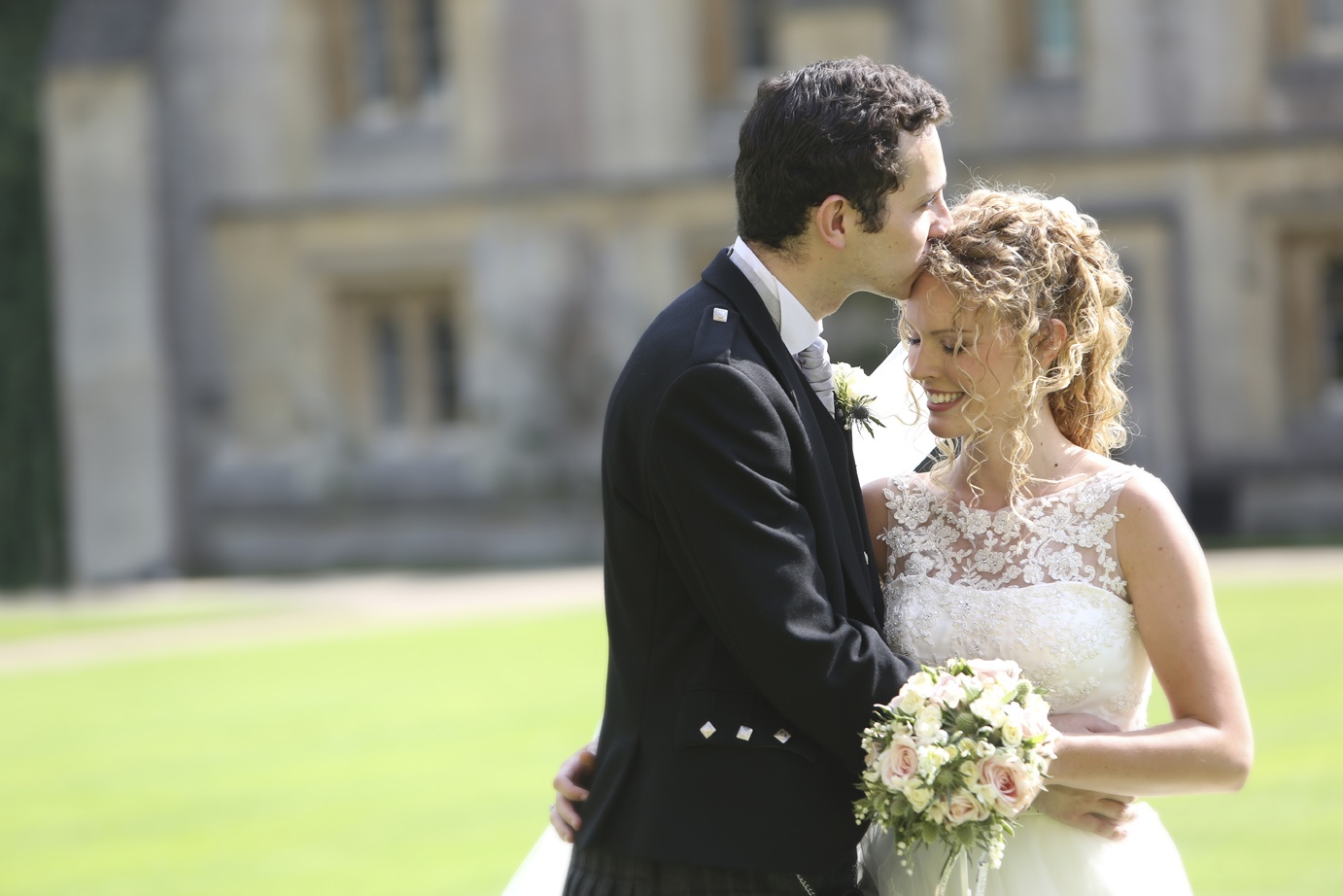 A groom resting his forehead against his bride's, castle grounds, Nadine Pyke Make Up Artist