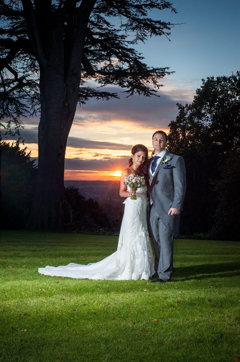 A bride and groom in a grassy field at sunset, Nadine Pyke Make Up Artist