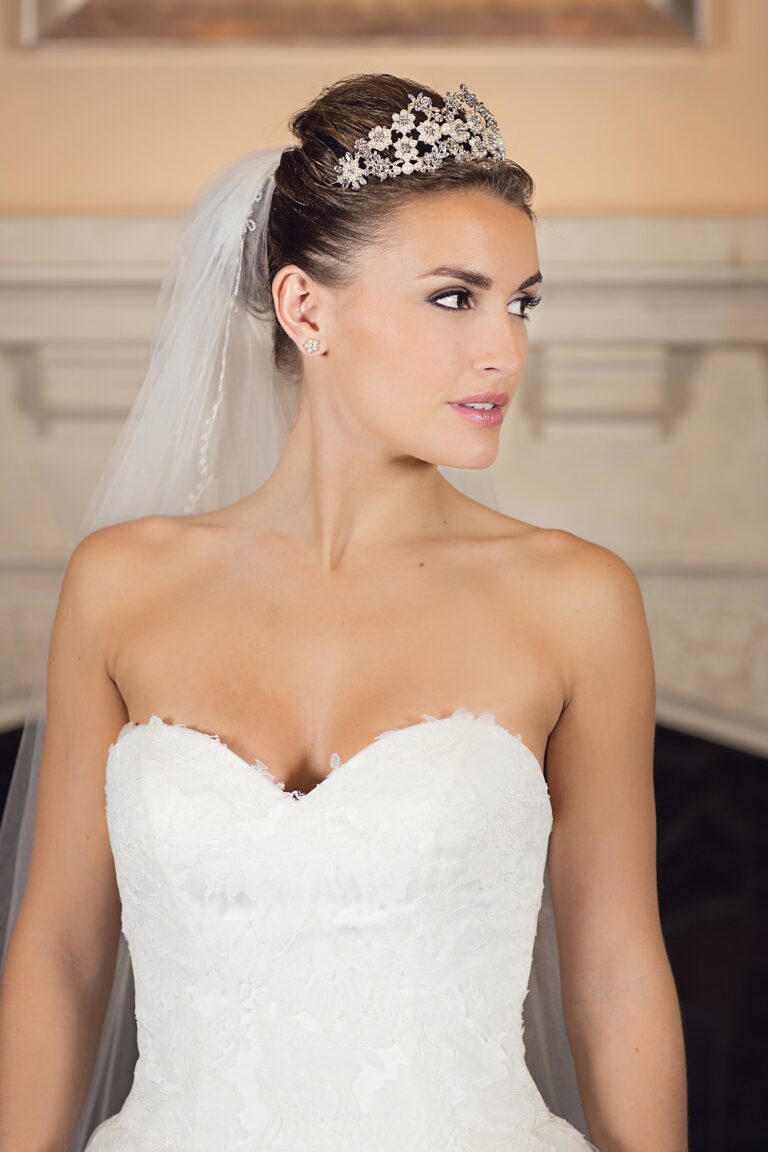 A bridal portrait in a crystal star tiara, sweetheart-neckline lace gown, Nadine Pyke Make Up Artist