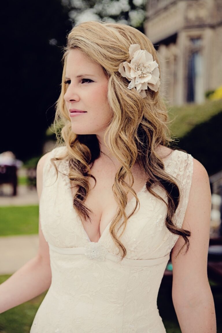 A close bridal portrait, loose waved hair and a flower hair accessory, Nadine Pyke Make Up Artist