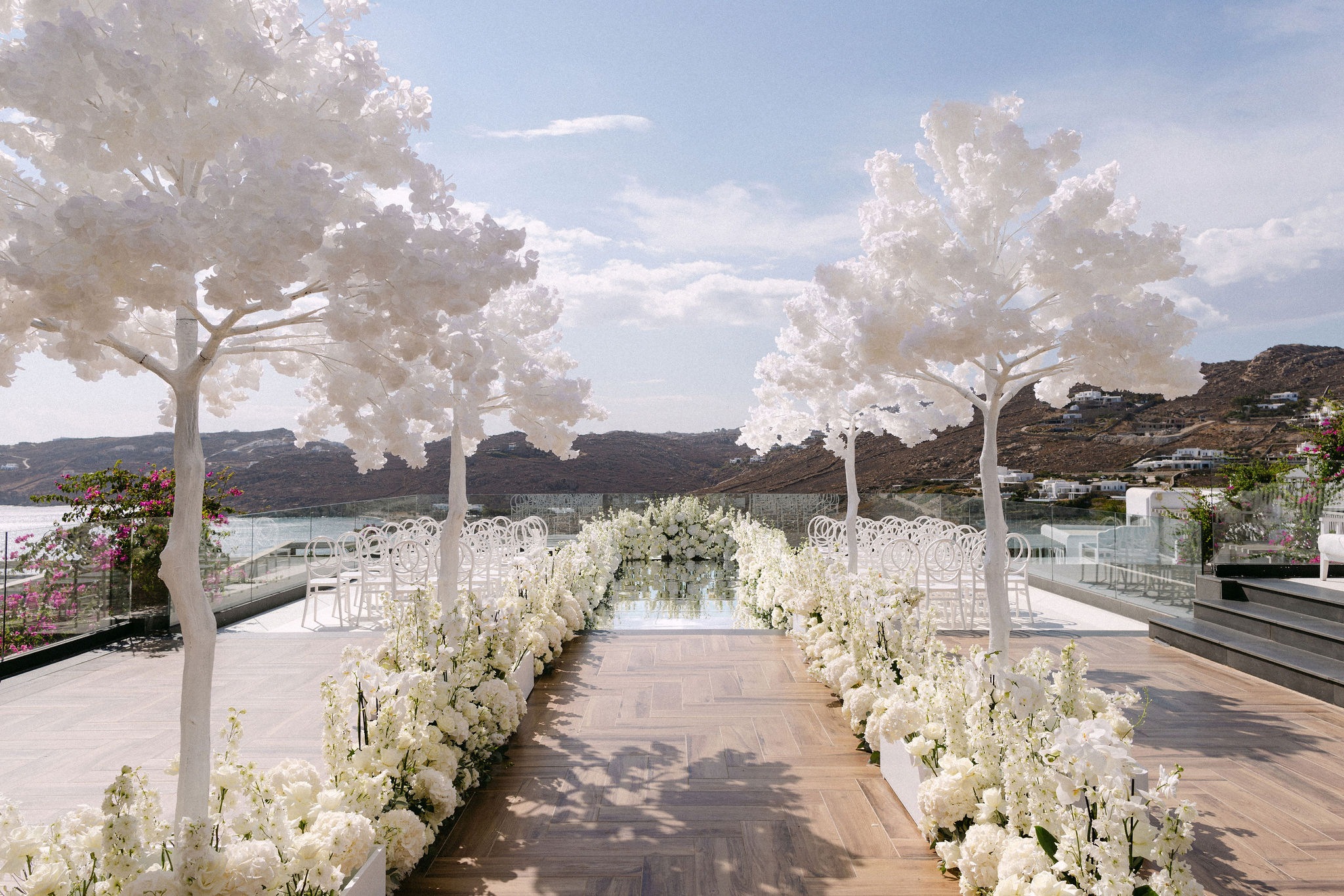 White trees and floral aisle above the sea on Mykonos, Naido Wedding