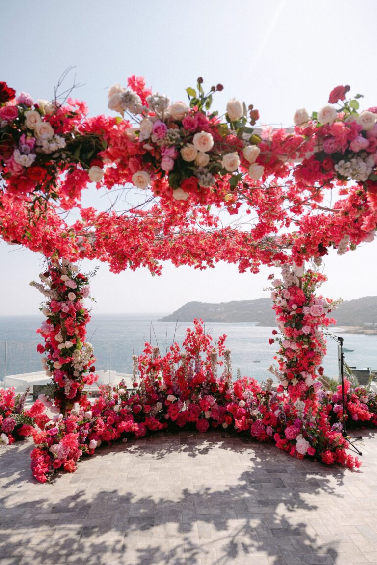 Crimson floral canopy above the sea, Naido Wedding