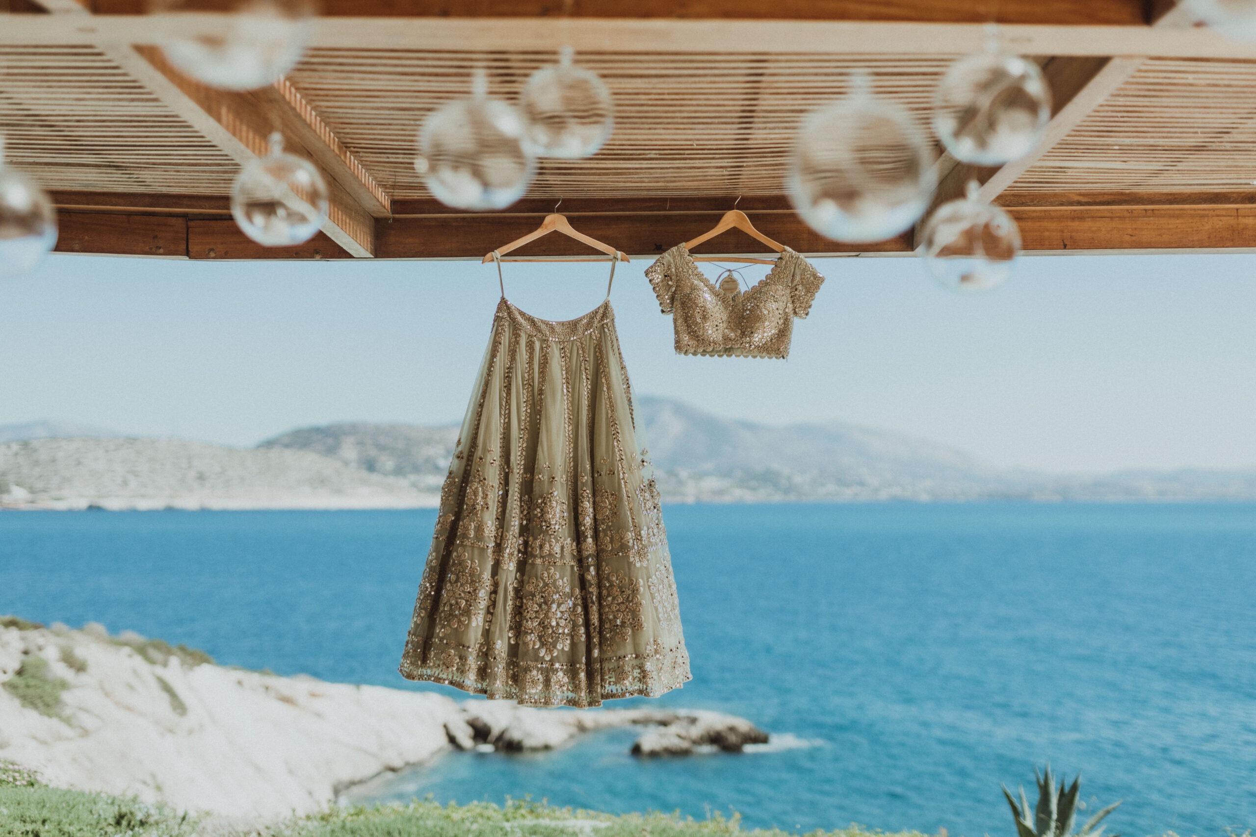 Embroidered outfit hanging above the sea, Naido Wedding