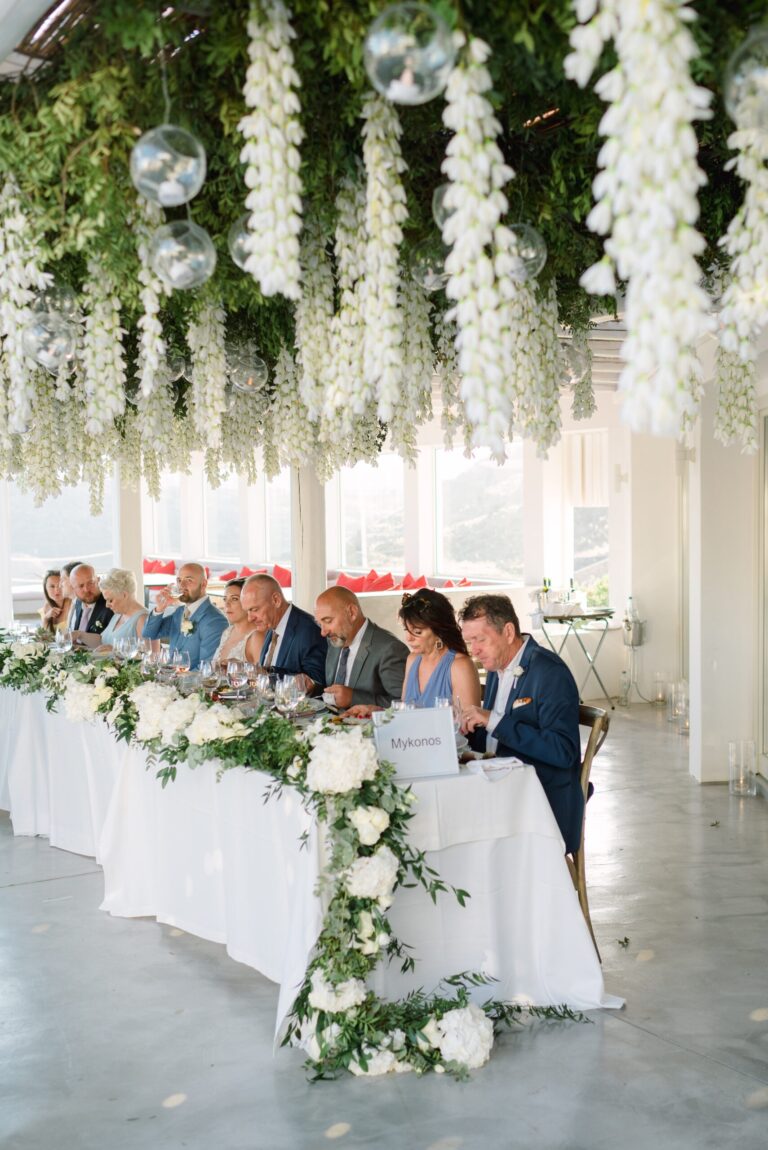 Head table beneath hanging white flowers, Naido Wedding