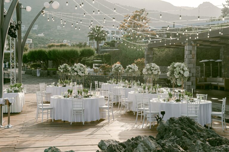 Round tables for the reception under festoon lights at a resort, Naido Wedding