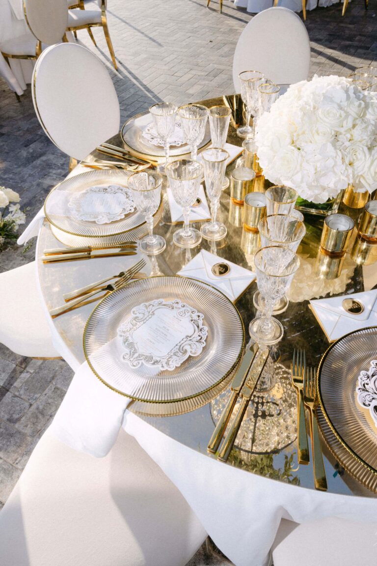 Table setting with gold cutlery, glassware and white flowers, Naido Wedding