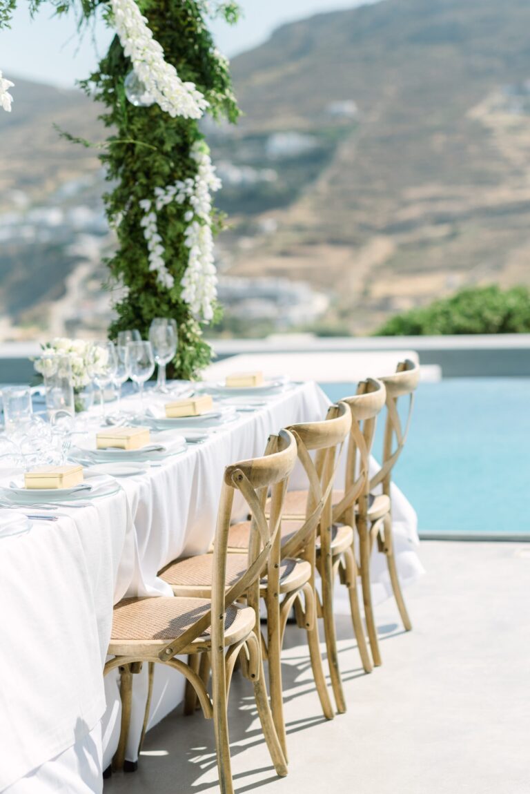 Long table with a green garland beside a pool, Naido Wedding