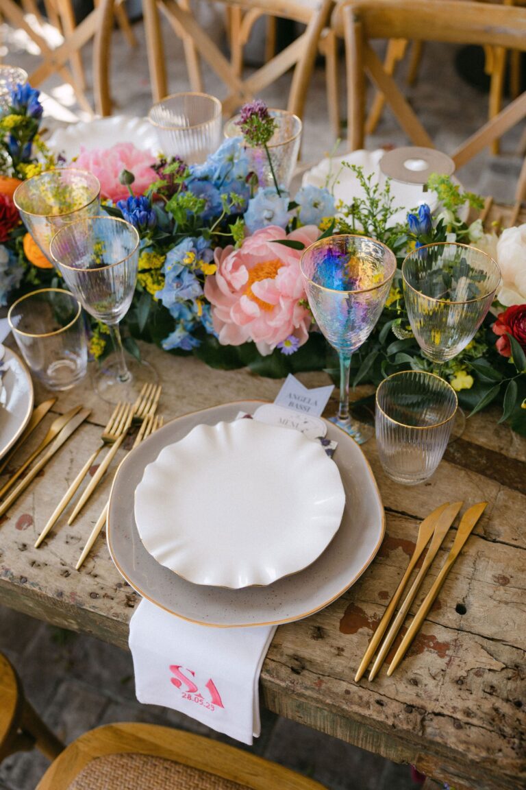 Place setting with colourful flowers and gold cutlery, Naido Wedding