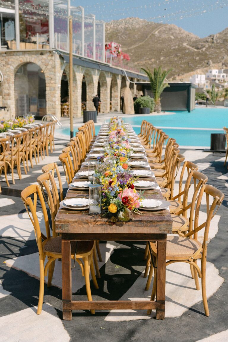 Long wooden table on a terrace beside a pool, Naido Wedding