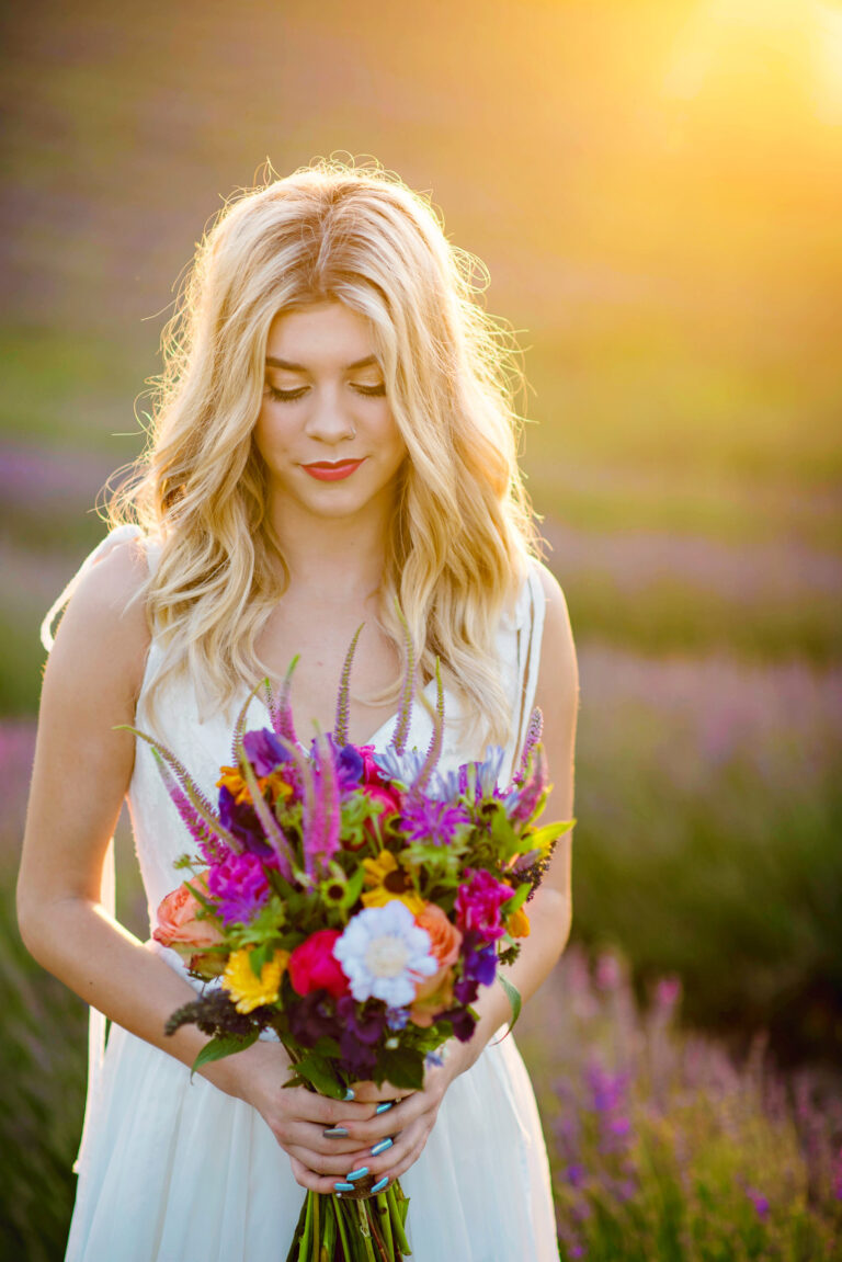 A bride in a Naomi Neoh gown holding a bouquet in a lavender field, Lavender Lust styled shoot