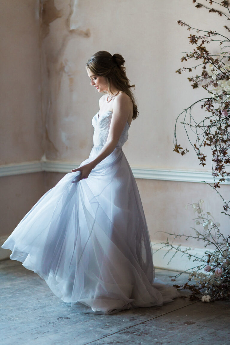 A bride in a Naomi Neoh tulle gown in a pale room, The Violet Vigour styled shoot