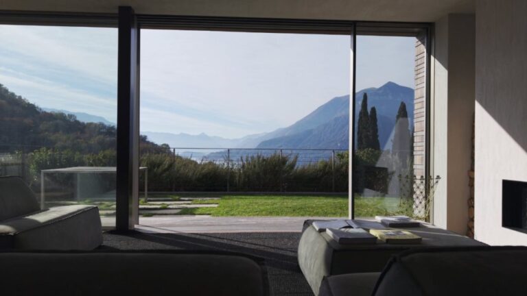 The glass living space at Villa Nascosta at dusk, Natasha Barbato
