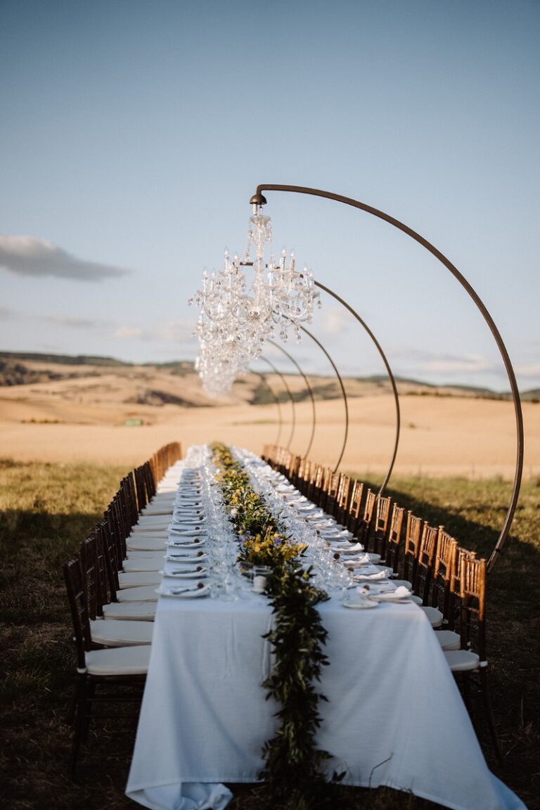 A chandelier over a table in the Tuscan wheat, Natasha Barbato
