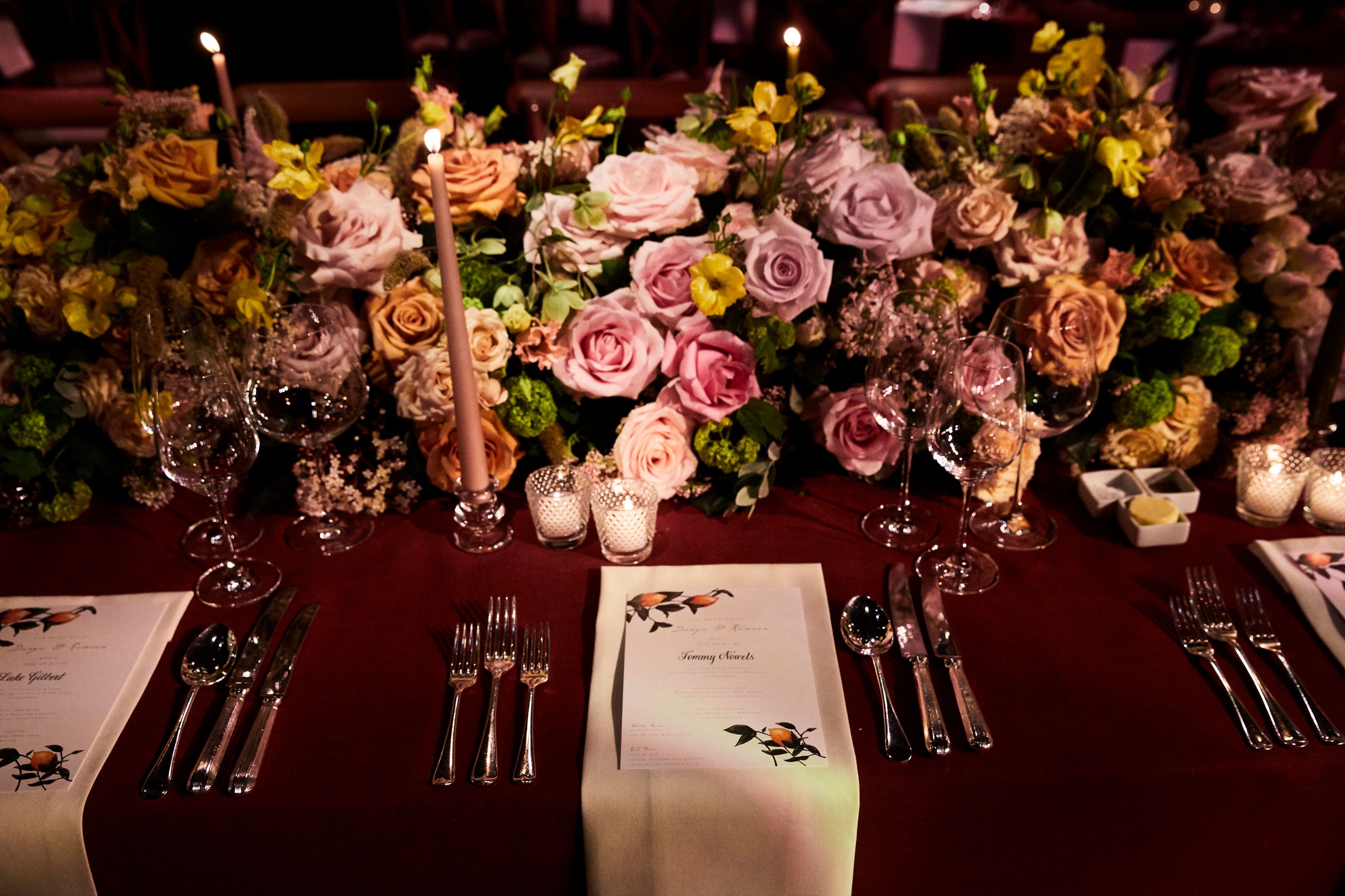Roses and a candlelit dinner table at a Niemierko wedding at Battersea Evolution