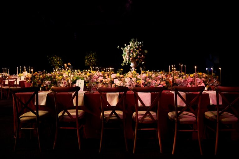 A long reception table set for dinner at a Niemierko wedding at Battersea Evolution