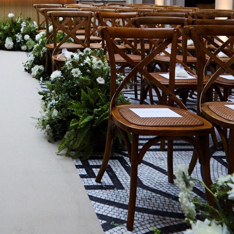 A flower-lined ceremony aisle at a Niemierko wedding at Lime Wood