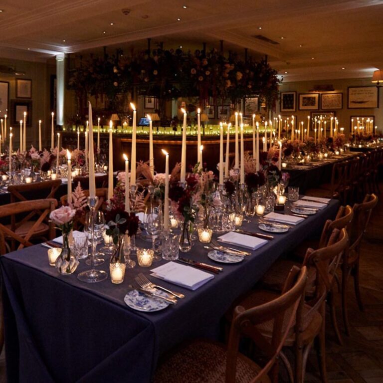 A candlelit dinner table at a Niemierko wedding at Lime Wood