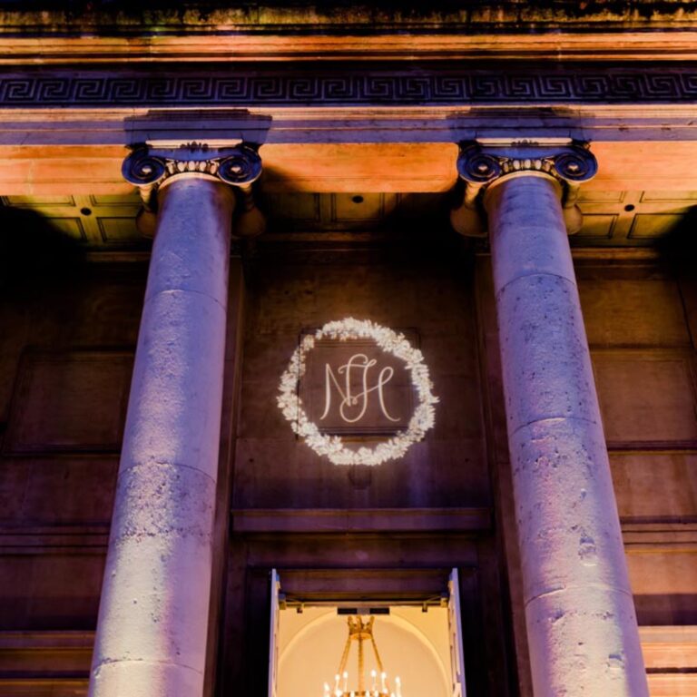 Columns lit with the couple monogram at a Niemierko wedding at One Marylebone