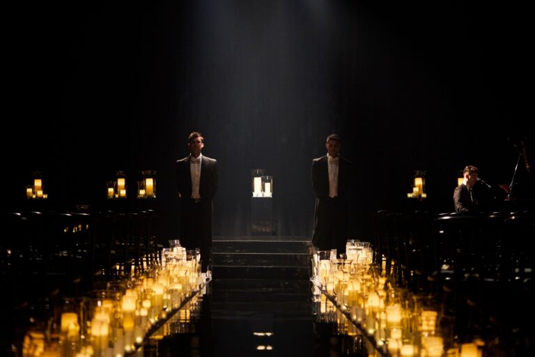 Rows of candles in a darkened space at a Niemierko wedding at Battersea Evolution