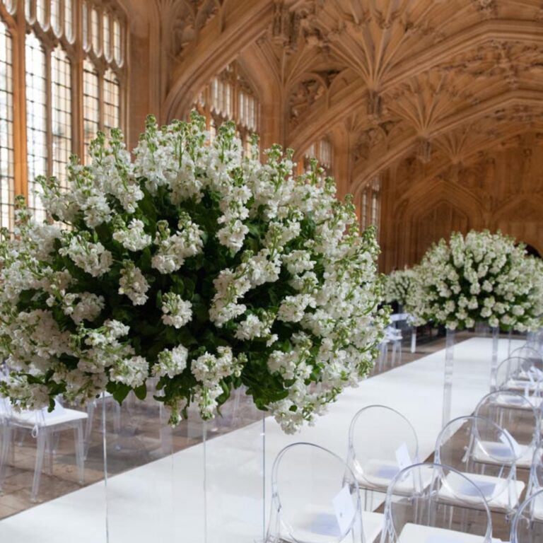 White flowers in a vaulted library at a Niemierko wedding at Oxford University