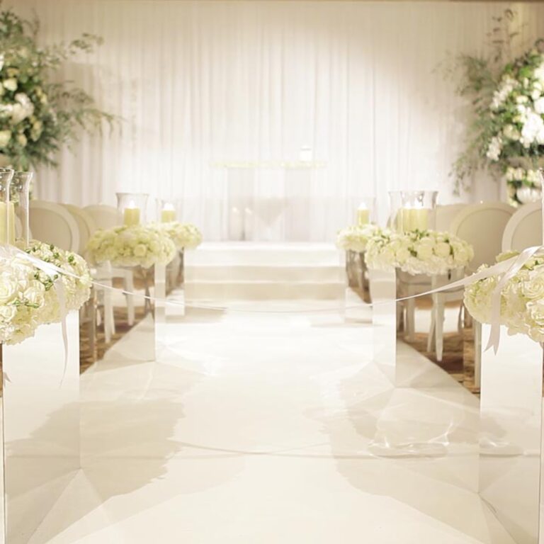 A white aisle and flowers at a Niemierko wedding at Four Seasons Hampshire