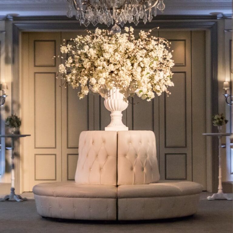 White flowers in a sitting area at a Niemierko wedding at The Savoy