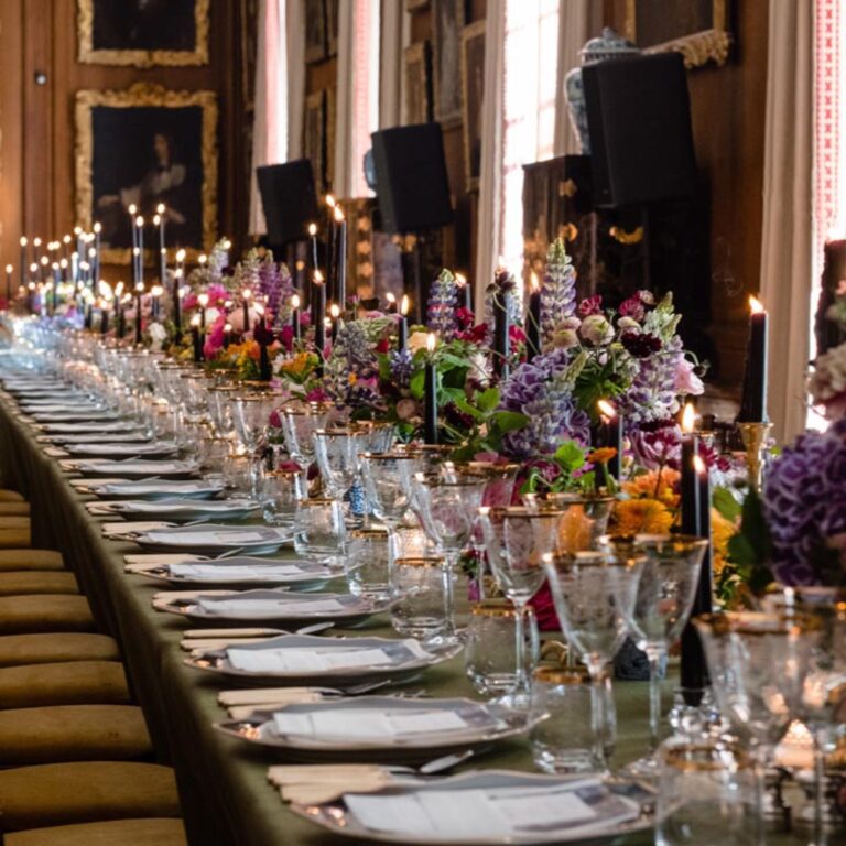 A long dinner table in a gallery at a Niemierko wedding at Althorp House
