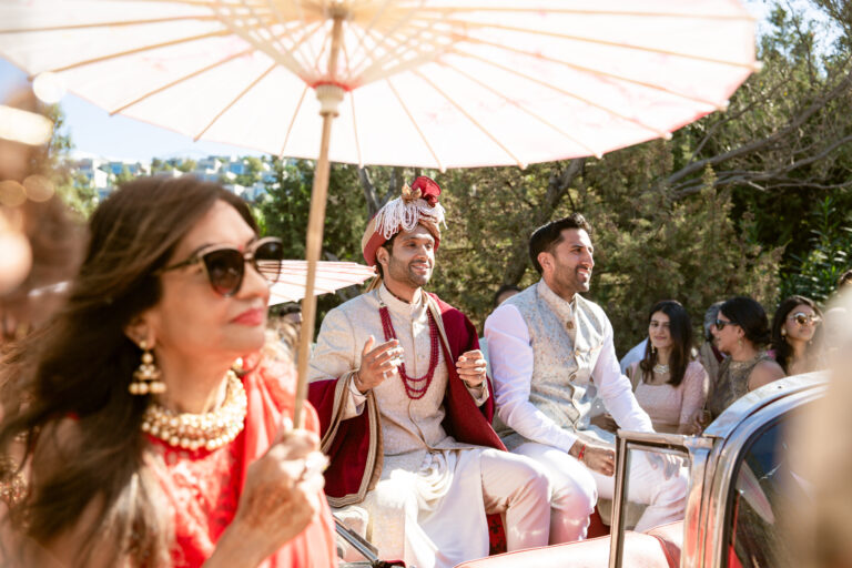 Groom travelling in the baraat procession under a parasol, Nilyum Wedding and Event Design