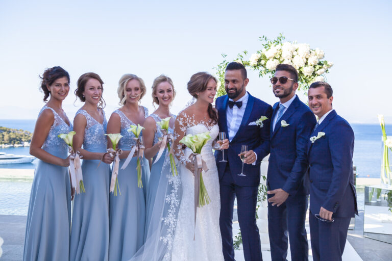 Bridal party and groomsmen gathered at the ceremony site, blue dresses and navy suits, Nilyum Wedding and Event Design