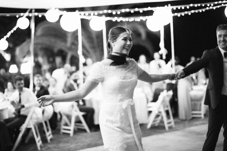 Black and white first dance beneath festoon lights, Nilyum Wedding and Event Design